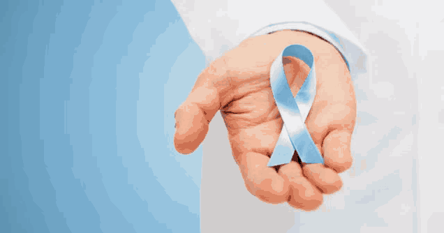 a person holding a blue ribbon in their right hand