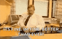 a man in a white shirt and tie is sitting at a desk with a computer and a printer .