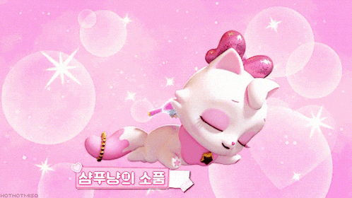 a white cat with a pink bow on its head is laying on a pink background