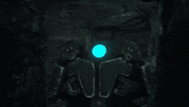 a close up of a pink light coming out of a hole in the ground .