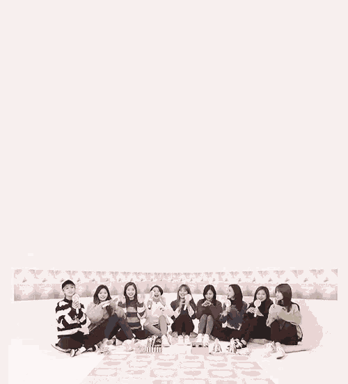 a group of girls are sitting on a couch with a white background