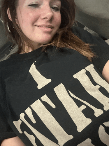 a woman wearing a black t-shirt that says " i like it "
