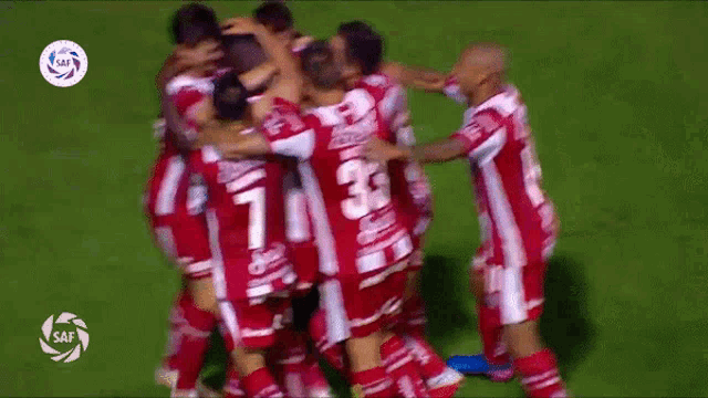 a group of soccer players are huddled together and one of them has the number 33 on their back