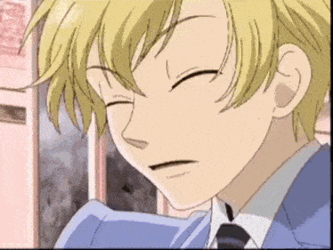 a close up of a boy with his eyes closed