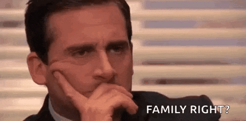 a man in a suit is holding his hand to his chin and asking , `` family right ? '' .