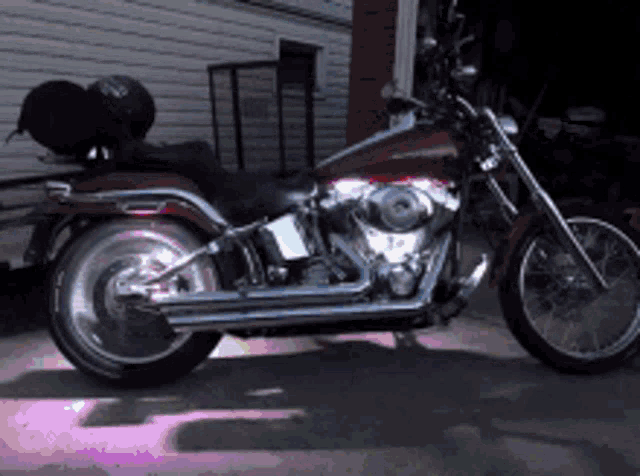 a harley davidson motorcycle is parked in front of a house