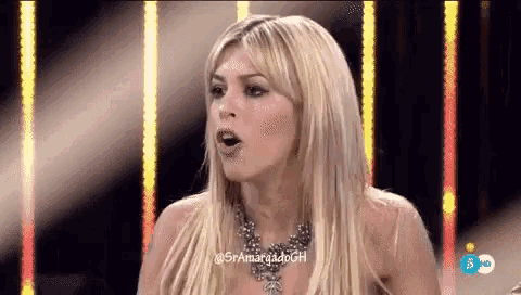 a blonde woman wearing a necklace is making a funny face on a television show .