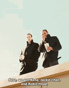 two men standing on top of a building with the words base we got xena jackie chan and robin hood below them