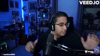 a man wearing headphones and glasses is sitting in front of a microphone with the words veed.io on the bottom right