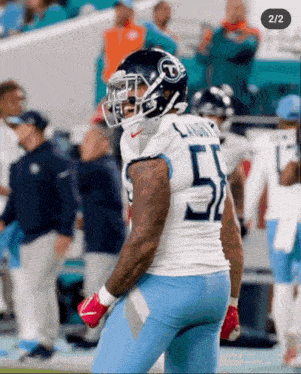 a football player with the number 51 on his jersey stands on the field