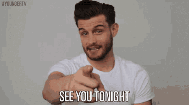 a man in a white shirt is pointing at the camera and says " see you tonight "