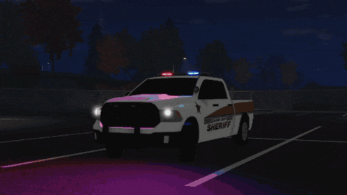 a sheriff truck is parked in a parking lot at night