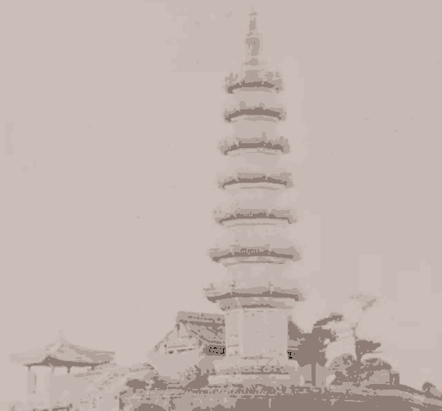 a black and white photo of a very tall building with a pink light behind it