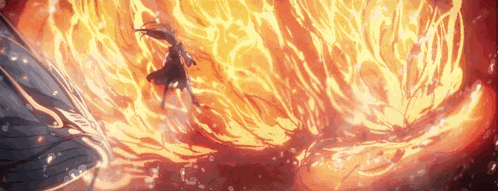 a woman is standing in front of a large fireball .