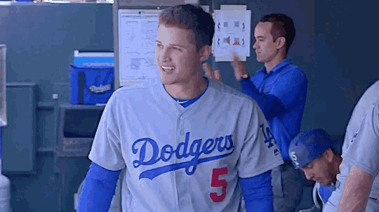 a man wearing a dodgers jersey number 5