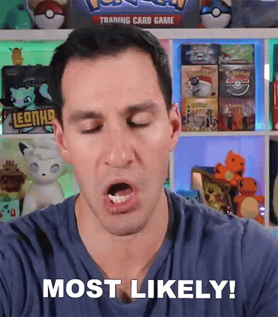 a man is making a face and saying most likely in front of a shelf full of pokemon cards .