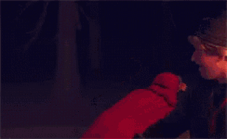 a girl in a red jacket is being held by a man and says it 's true love ..