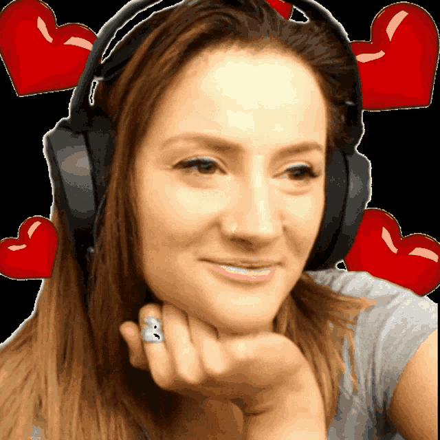 a woman wearing headphones with a ring on her finger