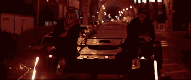 a blurred image of two people sitting in a dark tunnel with the letter r visible in the background