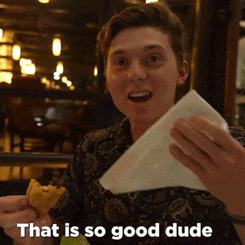 a man holding a napkin and a piece of food with the words that is so good dude written below him
