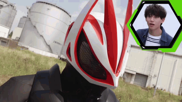 a man wearing a red and white helmet stands in front of a large building