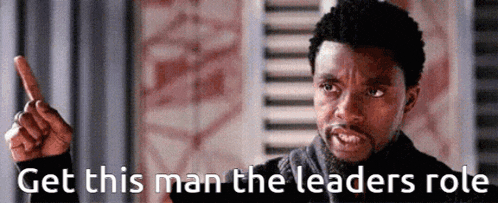 a man is pointing up with the words `` get this man the leaders role '' .