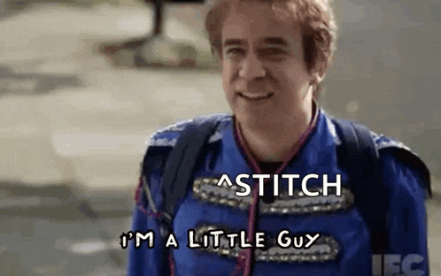 a man in a blue uniform is smiling and says `` stitch i 'm a little guy '' .