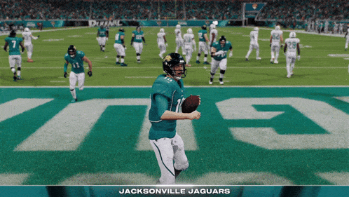 a jacksonville jaguars football player holding a ball