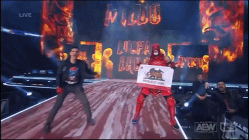 a wrestler holding a california flag on a stage with a aew logo in the corner