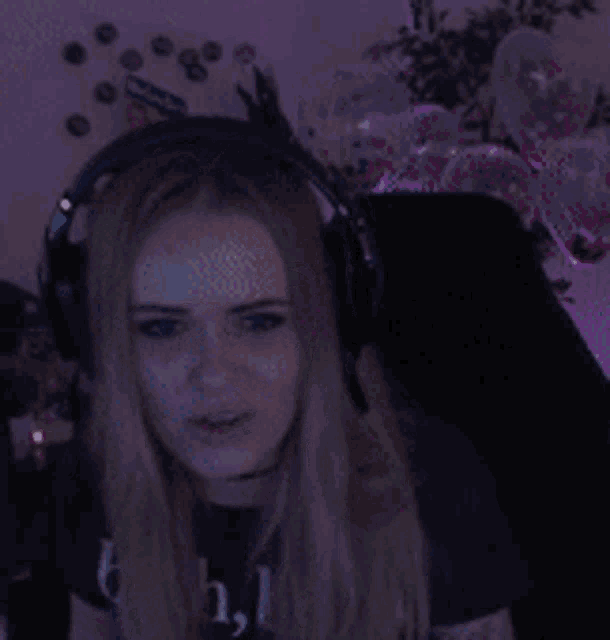 a woman wearing headphones and a t-shirt that says bitch