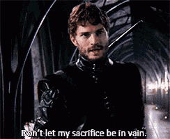 a man with a beard is holding a sword and saying " don 't let my sacrifice be in vain . "