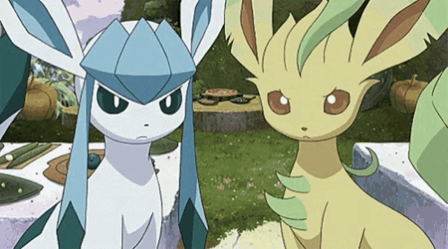 a couple of pokemon are standing next to each other in a field .