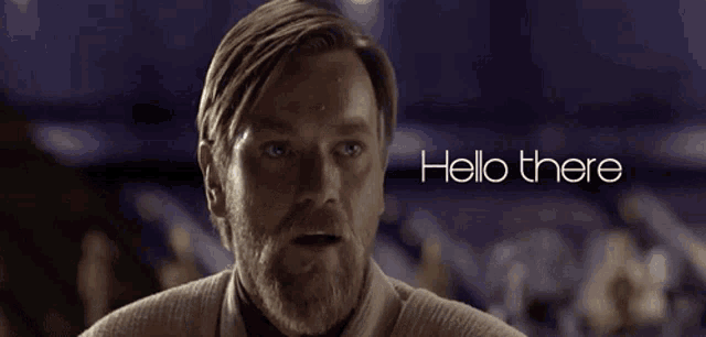 a man with a beard is standing in front of the words hello there