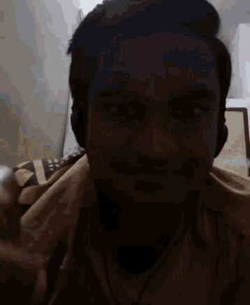 a man wearing headphones looks at the camera with a yellow blanket behind him