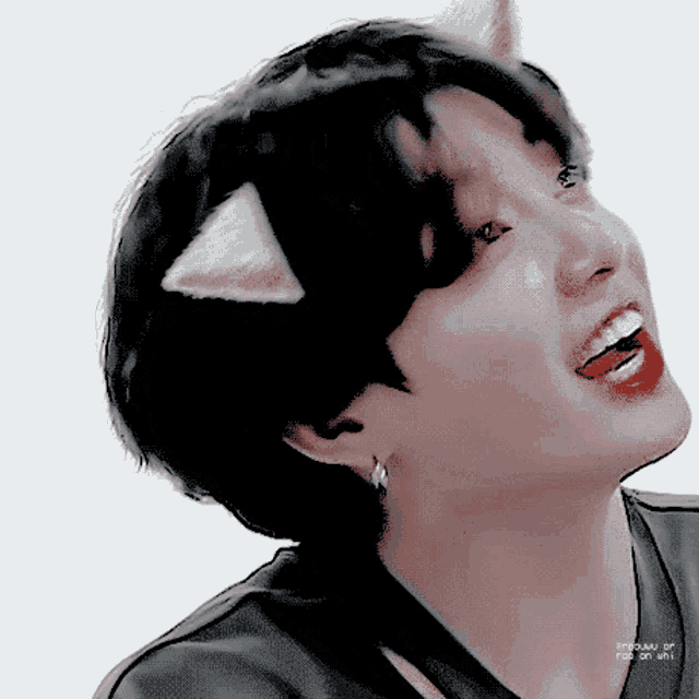 a close up of a person wearing cat ears and earrings