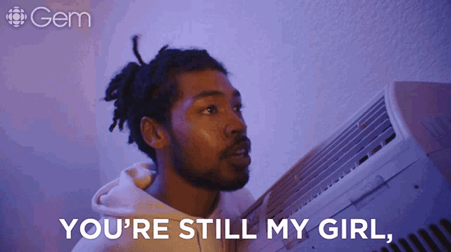 a man is holding an air conditioner with the words you 're still my girl