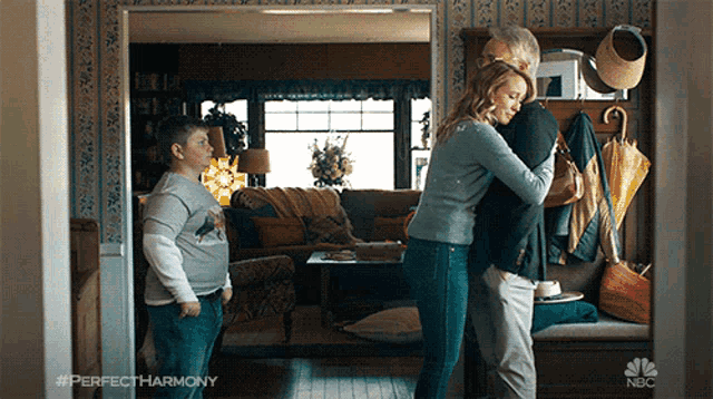 a family hugging in a living room with perfectharmony written on the bottom right