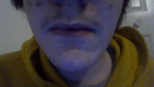 a close up of a person 's face with a yellow hoodie on