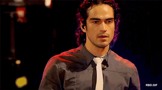 a man singing into a microphone with the word rbd.c on the bottom right