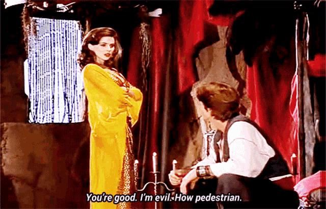 a woman in a yellow dress says " you 're good i 'm evil how pedestrian " to a man