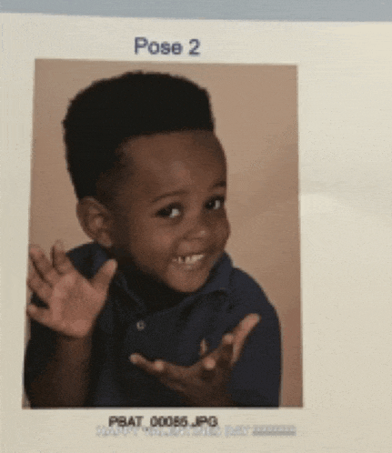 a picture of a young boy in a blue shirt with the caption pose 2
