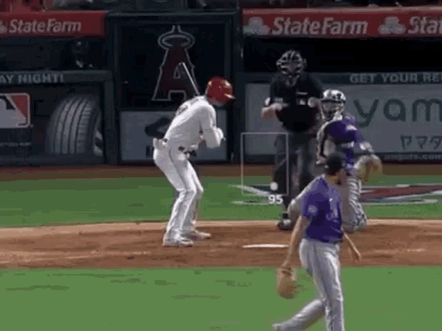 a baseball game is being played on a field with a catcher and umpire .