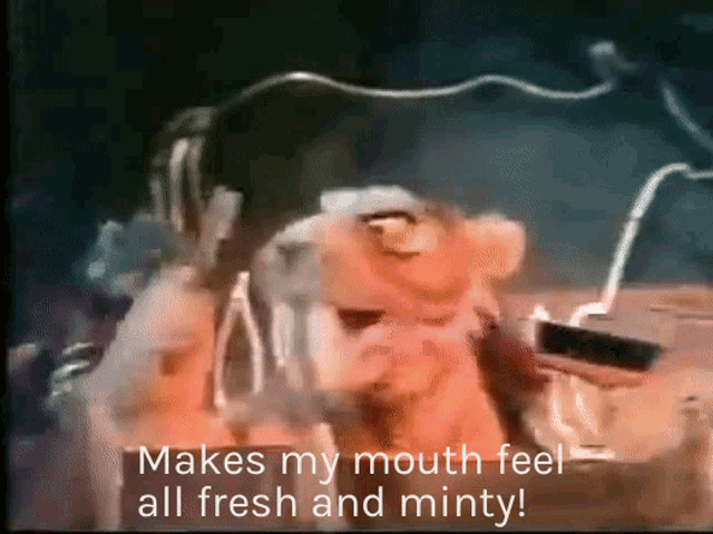 a cartoon character says " makes my mouth feel all fresh and minty " while wearing headphones
