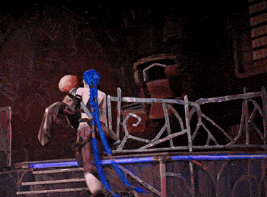 a woman with blue hair is standing in front of a fence that says ' n ' on it