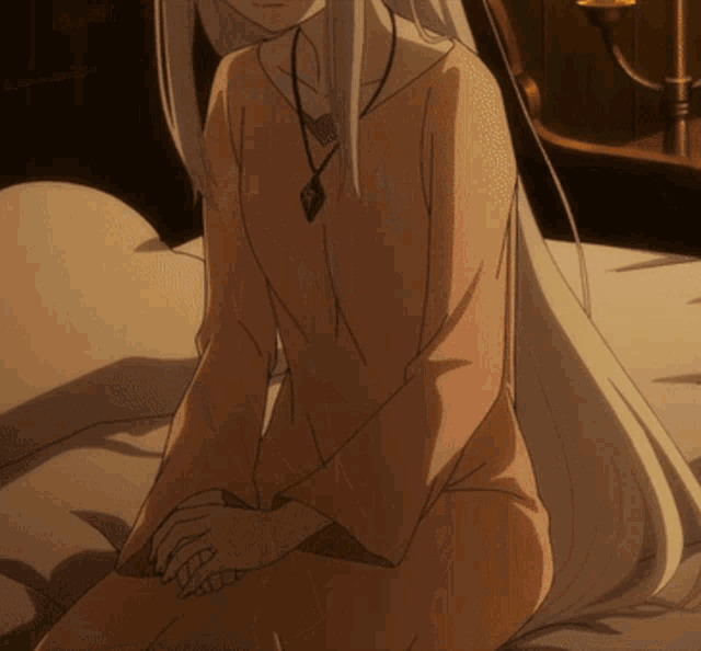 a woman with long white hair is sitting on a bed with her hands folded