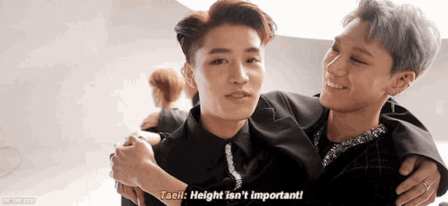 two men are hugging each other and one of them is saying taeil height is n't important .