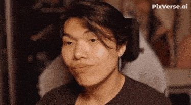 a young man in a wheelchair is making a funny face and looking at the camera .