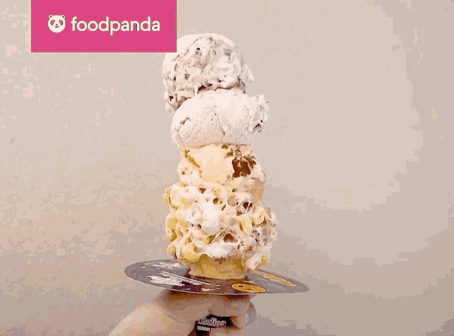 a stack of ice cream cones on a plate with a foodpanda logo
