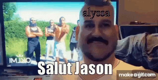 a man with a mustache is standing in front of a television with the words salut jason on his head .