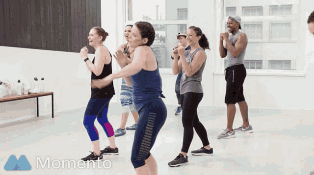 a group of people are dancing in a room and the word momento is on the bottom